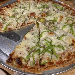 Pizza with sausage, green and jalapeno peppers and onions.