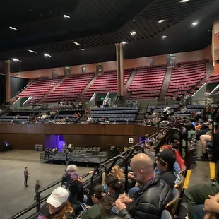 a crowd of people sitting in the bleachers