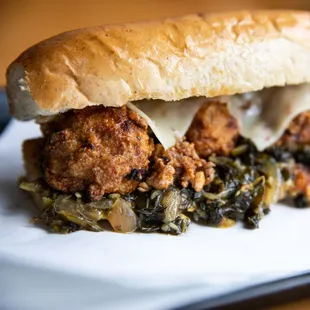 Mamma Mia--Garlic &amp; ginger chicken meatballs, Szechuan pork ragout, chili braised greens, pepper jack, grain mustard, garlic butter bun