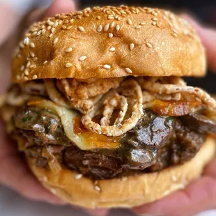 Beefy Diane--braised beef chuck, creamy garlic mushrooms, caramelized swiss, crispy onion straws, garlic butter toasted sesame seed bun