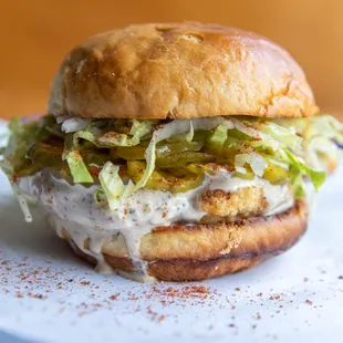 ODE TO BIG BOB--Crispy chicken thigh, BBQ dry rub, Alabama white sauce, spicy pickle, iceberg, garlic butter toasted sesame seed bun