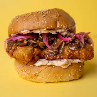 CBP-Fried chicken thigh, BBQ bacon Jam, pimento cheese, pickled red onions, garlic butter toasted Charpier&apos;s sesame seed bun