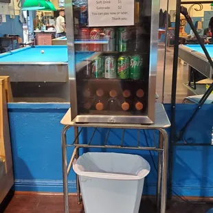 a billiards machine with a sign on it