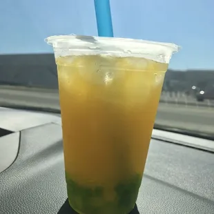 Passion fruit and peach green tea with popping peach boba and green tea jellies. (Size small)