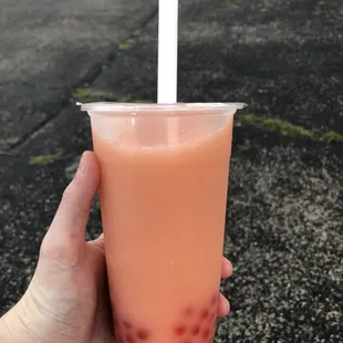 Strawberry passion green tea with coconut milk and strawberry popping boba. So yummy!!
