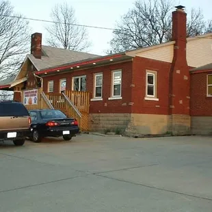two cars parked in front of the building