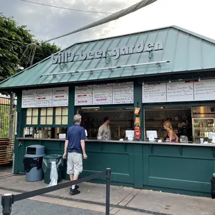 a man standing in front of a bar