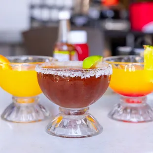three cocktails on a table