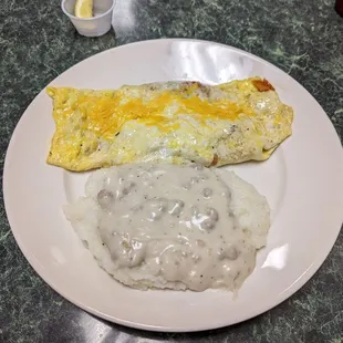 Ground beef omelette w grilled veg n cheese and awesome sausage gravy over grits.. they know good grits!