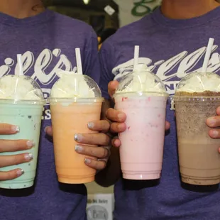 three people holding drinks