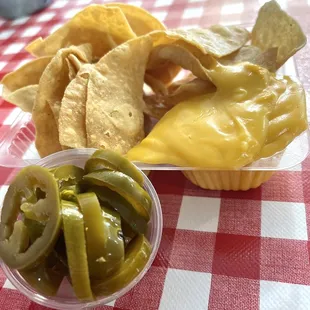 a bowl of chips and pickles