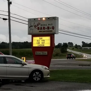 a car parked in front of a sign