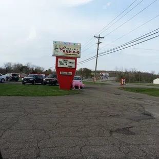a pink pig in the parking lot