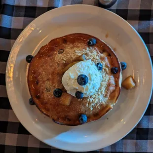 Fluffy blueberry pancake with cooked pears and a sizeable scoop of vanilla-flavored mascarpone.