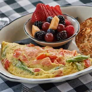 an omelet, fruit, and bread