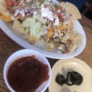 Chicken nachos with jalapeños on the side