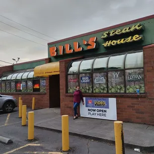 a woman standing in front of the restaurant