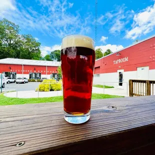 Sitting on the deck that is attached to the Taproom looking over at the Brewhouse where the craft beer &amp; hard seltzer magic happen!