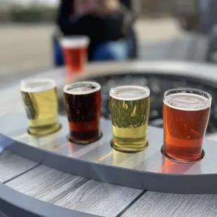a flight of beers on a table