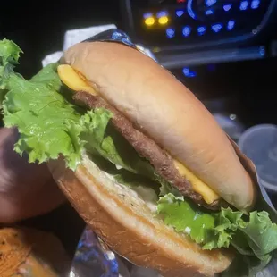 a hamburger with lettuce and cheese