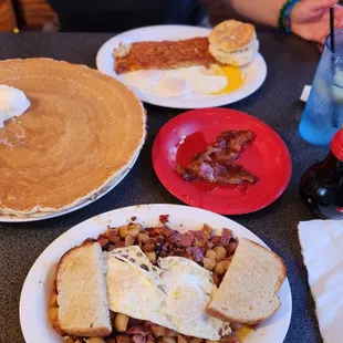 a breakfast of pancakes, eggs, bacon, and pancakes