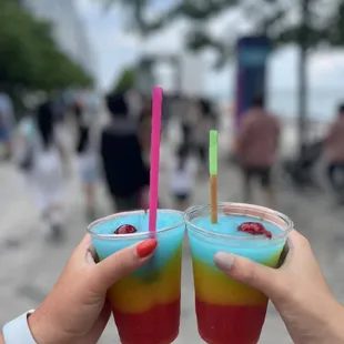 two people holding drinks