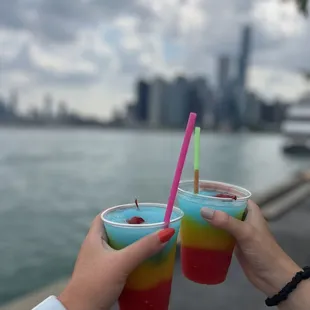 two people holding drinks