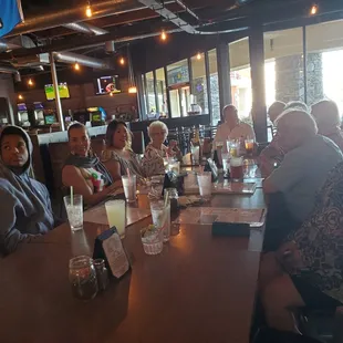 a group of people sitting at a bar