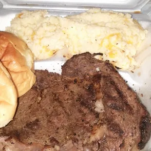 Steak and cheesey rice with salad and rolls..