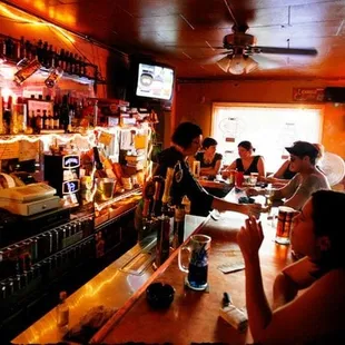 a group of people sitting at a bar