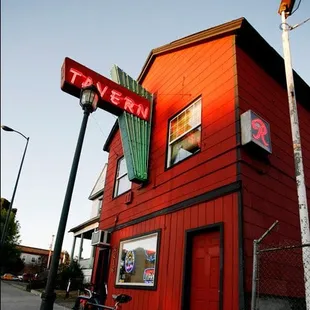 a red building with a neon sign
