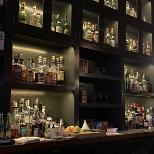 a bar with liquor bottles on the shelves