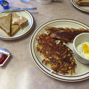 Build your own breakfast: greasy hash-browns, two cooked- through poached eggs, bacon and wheat toast.