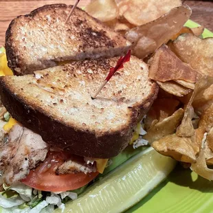 Hot turkey and cheddar sandwich with a side of homemade chips