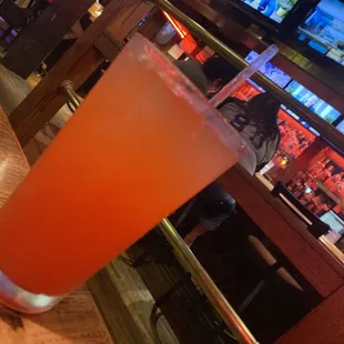 a tall glass of orange juice