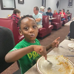 a young boy eating a meal