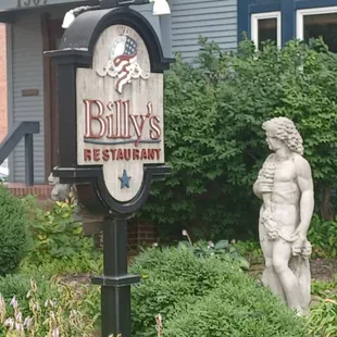 a statue in front of a restaurant