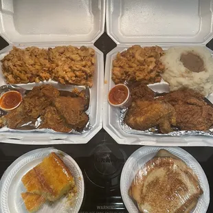 two trays of fried chicken, mashed potatoes, and a side of rice