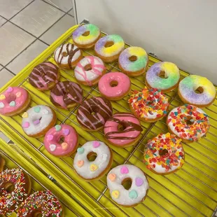 a variety of donuts on a cooling rack