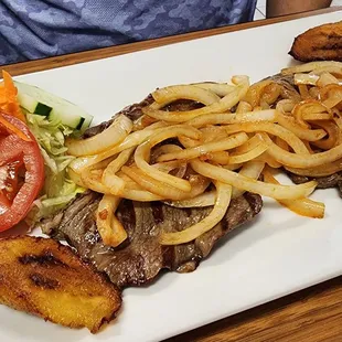 Bistec Encebollado: Top round steak with juicy grilled onions