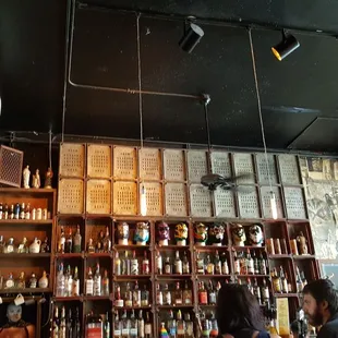 Mexican wrestling masks on display at the bar.