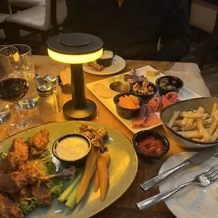 A bountiful table: charcuterie, buffalo wings, truffle fries, and Pessimist red wine from Paso Robles