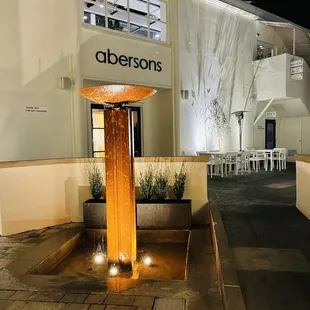 a fountain in front of a restaurant