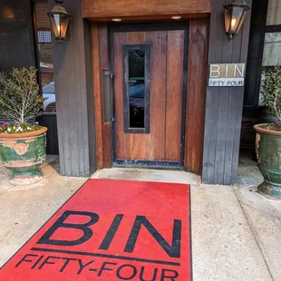 Outside. Storefront. Entrance. Bin 54 red carpet.