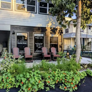 two lawn chairs in front of a building