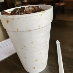 donuts in a paper cup with chopsticks