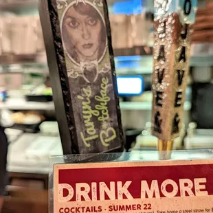 a drink more sign in a restaurant