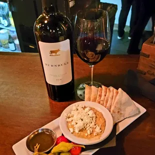 a plate of food and a glass of wine