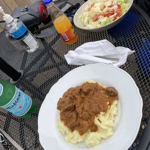 Goulash with mashed potatoes and Cesar salad