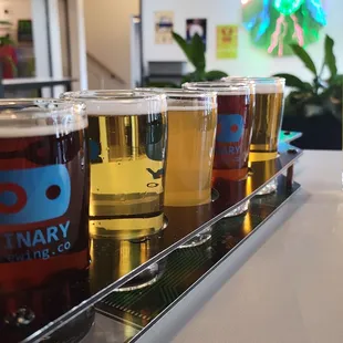 a row of beer glasses on a bar